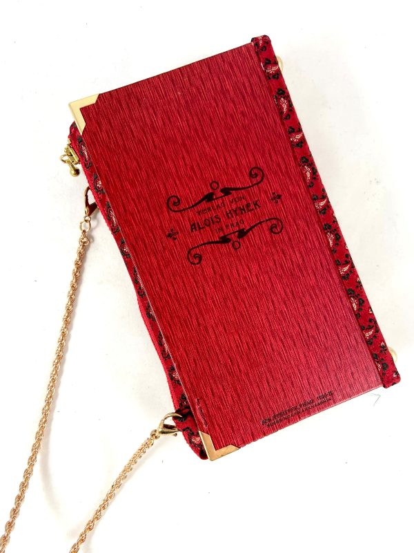Tasche/Clutch aus einem kleinen Büchlein der Serie "Moderne Bibliothek" in rot, am Cover ein großer prächtiger Vogel, schön geprägtes Cover mit Titel "Der Über-Alvin" und " Die neue Magdalene", kombiniert mit einer roten Trachtenkrawatte passend zum Cover.